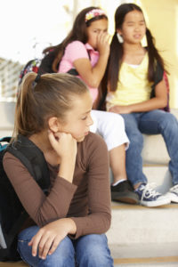 image of girl being bullied by a group of other girls